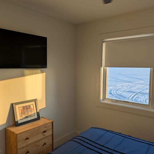 BEDROOM #1 (MAIN FLOOR):  Features a queen-size bed, ceiling fan, nightstands, nightlamps, dresser, mirror, private television, closet, and a great view of Crystal Lake!