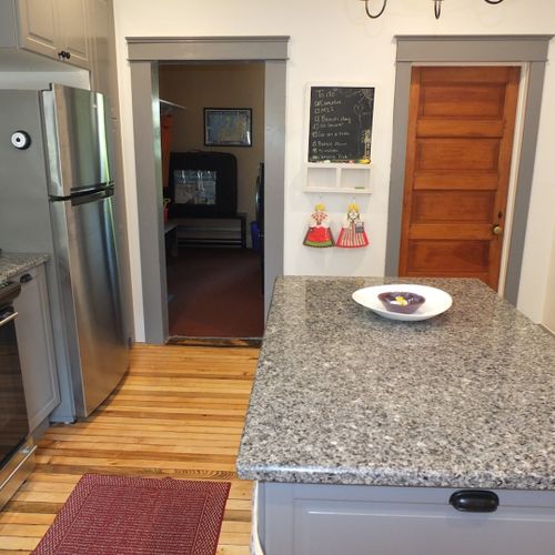 Kitchen:  another angle, showing the entrance to the laundry room on the left and the door to the first floor bathroom on the right. (the back door to the house opens into the laundry room. )