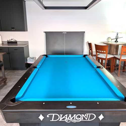 GAME ROOM (LOWER LEVEL):  The home has an incredible game room on the lower level with a championship pool table and large screen television.