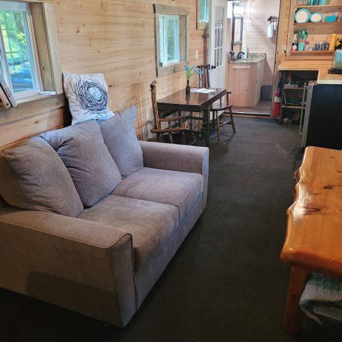 Living area:  sofa, dining table, and kitchenette