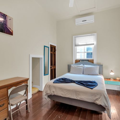 Serene bedroom w/ soft linens & a calm, uncluttered feel.
