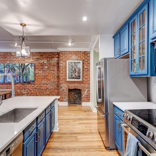 Functional kitchen space w/ ample storage & striking blue cabinets.