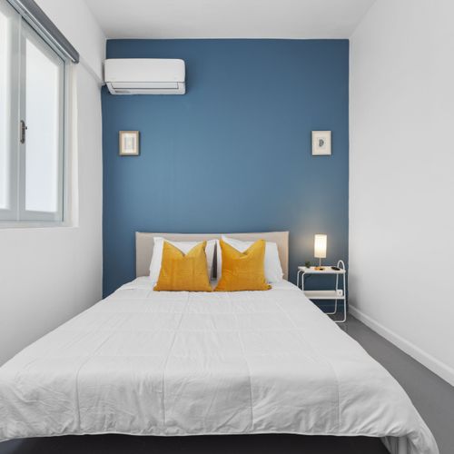 Your Serene Escape Awaits: This charming bedroom offers a tranquil ambiance with its chic minimalist design and comfortable, spacious bedding—perfect for a restful night.