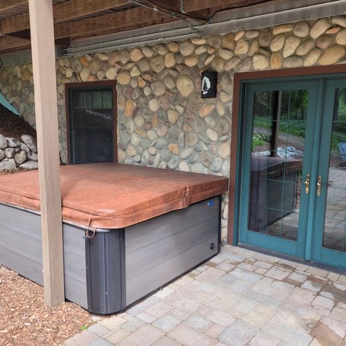 Exterior:  the hot tub on the backyard patio just outside the lower level entrance to the back patio.