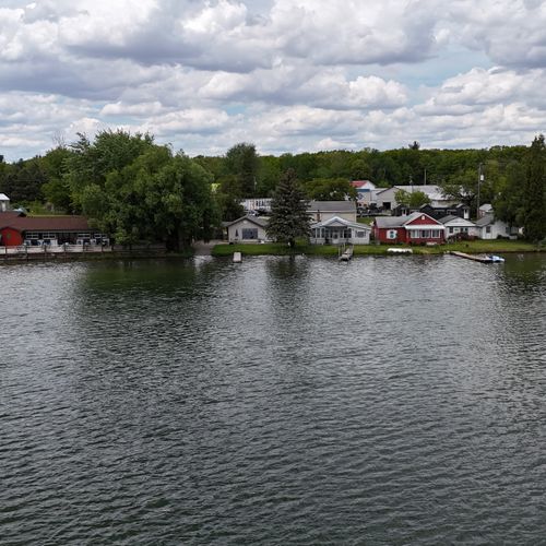 Exterior:  a front drone shot of the house with the lake