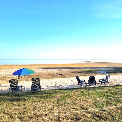 OVERVIEW:  Looking out from the house at the private beach, private bonfire ring, and Lake Huron