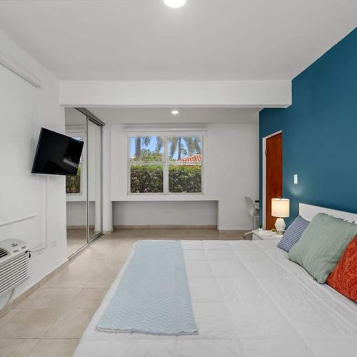 Enjoy the serene view of lush greenery through the large window.