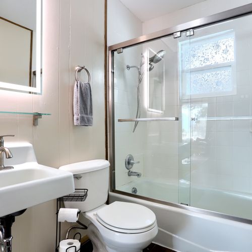 Freshen up in the remodeled bathroom with led vanity and glass enclosed bath with shower/tub option.