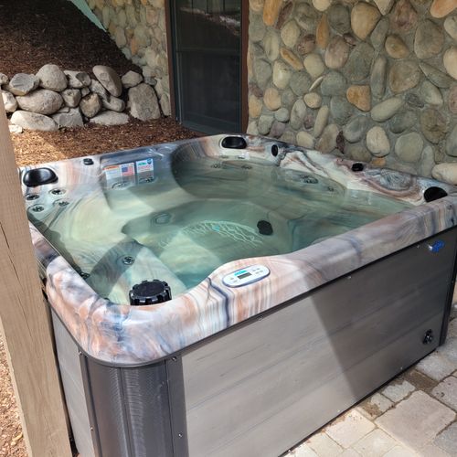 Exterior:  another photo of the hot tub on the backyard patio just outside the lower level entrance to the backyard patio.