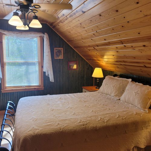 Bedroom #2 (upper level):  features a queen-size bed, chair, dresser, closet, ceiling fan, nightstands, and lamp