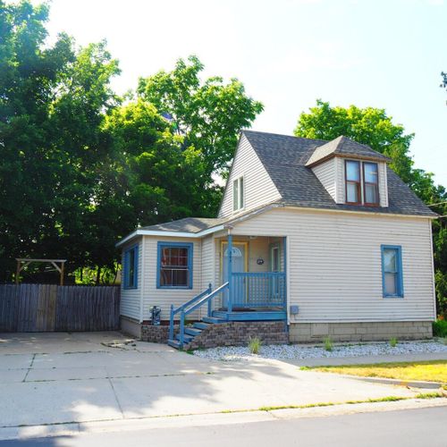 Exterior:  the front of the cottage in summer.