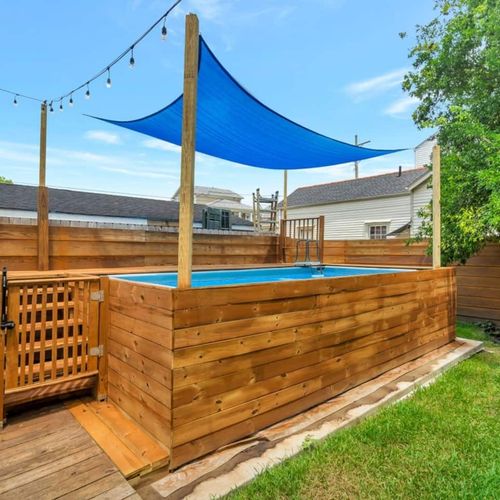 Private outdoor pool shaded by a blue sail — a refreshing midday retreat.