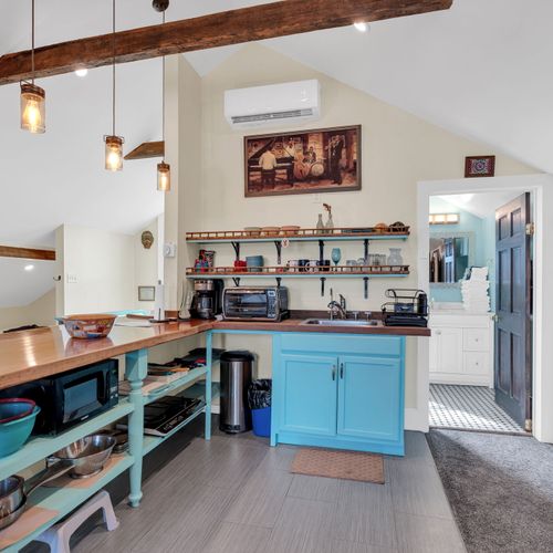 Upstairs kitchen w/ breakfast bar & vintage-inspired touches.