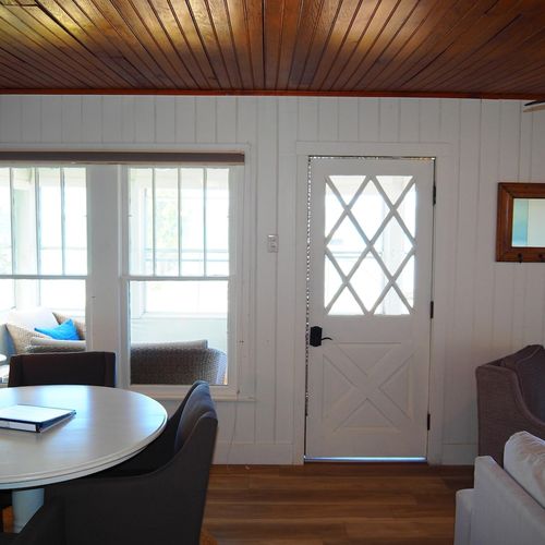 Living room:  the home has a very comfy living room with all new furniture, a ceiling fan, great views of crystal lake, a game table, and a wood-burning fireplace!