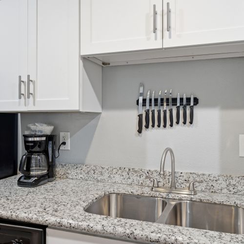 Compact & clean kitchen nook stocked w/ everyday essentials to keep you fueled.