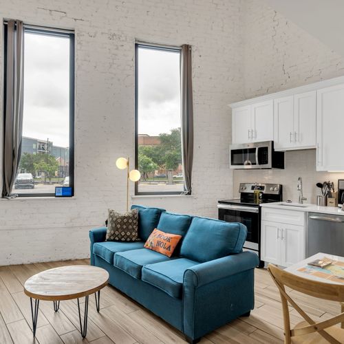 Kick back in a soulful living room with high ceilings, classic architectural touches, and the spirit of New Orleans just outside your window