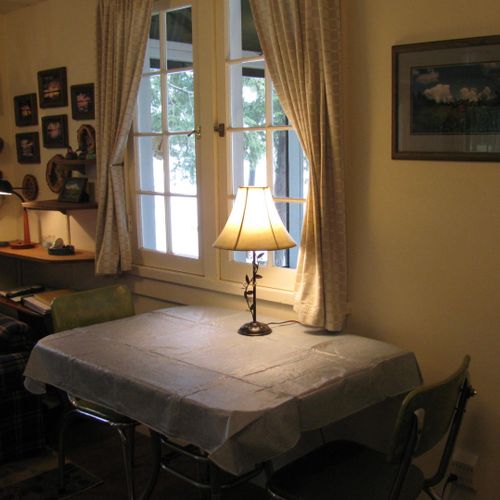 Living room:  the cabin has a cute little living room with a loveseat, dining table, and streaming television.