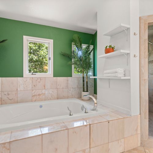 Stylish tub bathroom offering both charm and functionality in a bright space.