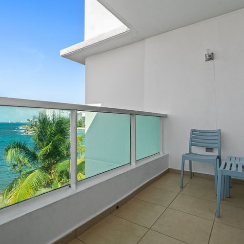 This incredible balcony view showcases the rich history and vibrant natural scenery of the area, featuring the iconic fort and ocean