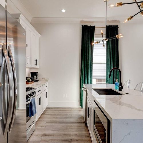 Functional kitchen w/ modern appliances & stylish teal accents throughout.