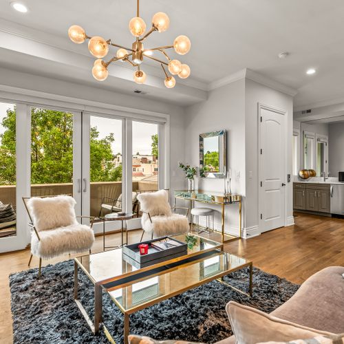 Light pours into this ample living space, highlighting sleek furnishings and a modern, elegant design.