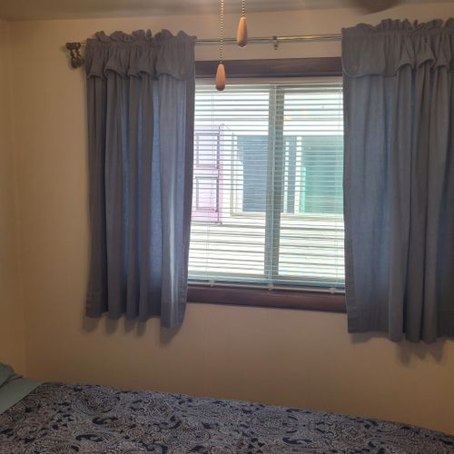 Bedroom #2:  features a full-size bed, ceiling fan, dresser, and closet.