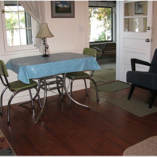 Living room:  the cabin has a cute little living room with a loveseat, dining table, and streaming television.