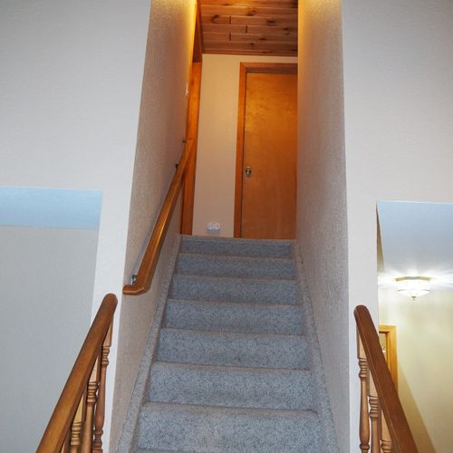 Stairs:  stairs from the first floor to the second floor. The entrance to each of the 3 upstairs bedrooms is near the top of the stairs, with the door to bedroom #2 shown in the photo.