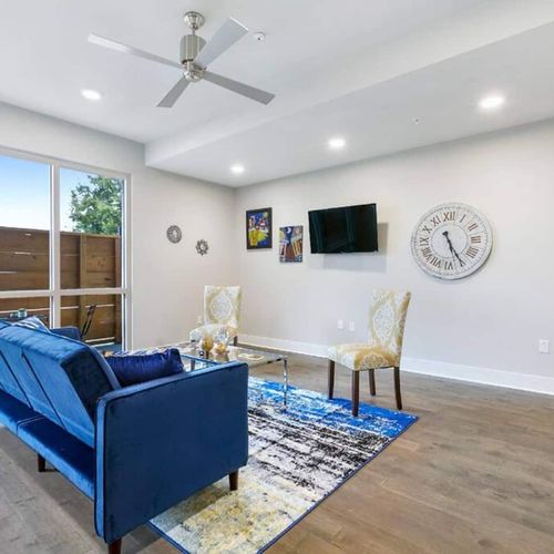 Spacious living room w/ smart TV & blue accent seating for movie nights in.