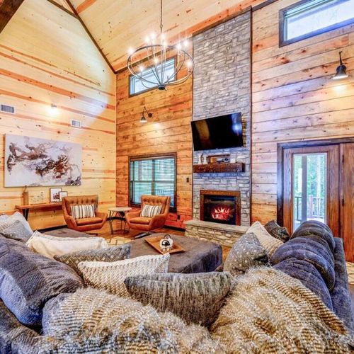 An oversized section sits around the electric fireplace and flat screen.
