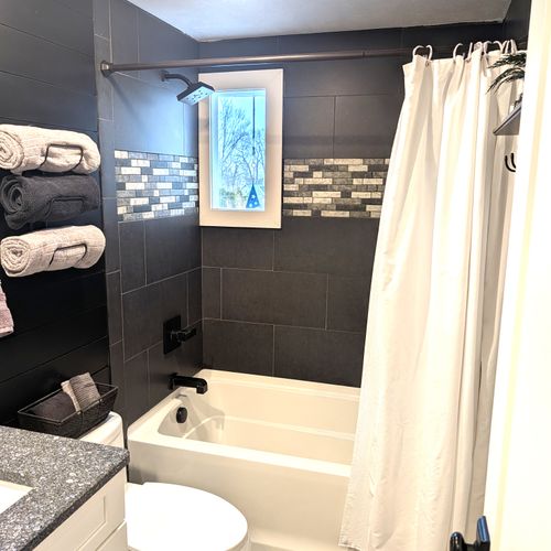 BATHROOM #1 (MAIN FLOOR):  Full bathroom on the main floor with a combination tub and shower.