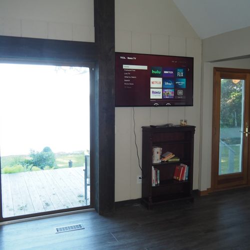 Living room:  the cottage has a cozy living room with a great view of bass lake. Includes live-streaming television with hulu, hbo max, pureflix, netflix, and disney+. (guests are not permitted to use the wood fireplace. )