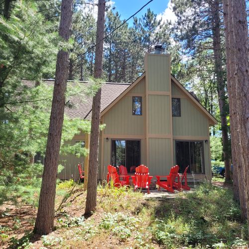 EXTERIOR:  Another view of the front of the cabin in the summer.