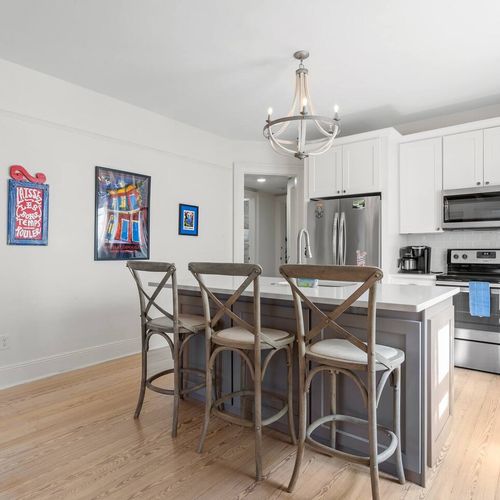 Stylish kitchen w/ large counter island — great for gathering & extra dining space.
