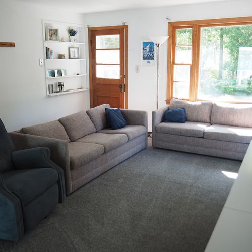 Living room:  the cottage has a very comfy and cozy living room with a sofa, loveseat, comfy chair, and television.