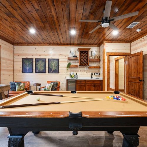 The pool table is at the heart of the game room.