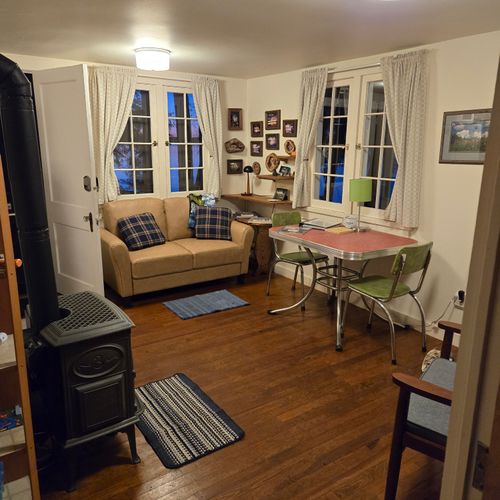 Living room:  the cabin has a cute little living room with a loveseat, dining table, and streaming television.