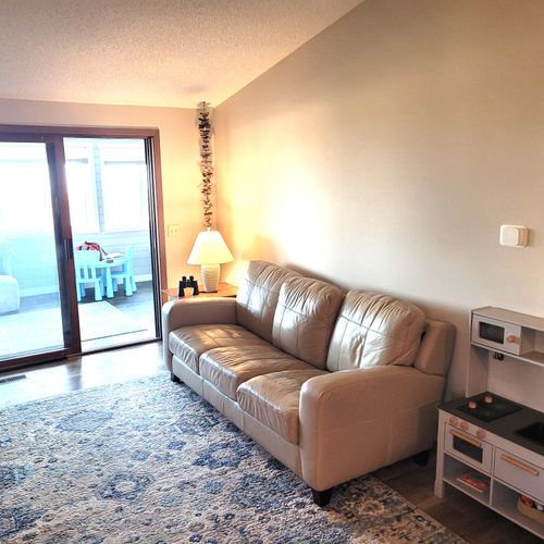 LIVING ROOM:  The home has a comfy living room with a wood fireplace.  (The television is now above the fireplace mantle.)  Note that the sliding doors lead out to the sunroom.
