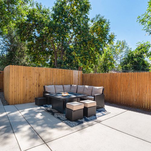 Private backyard oasis with cozy seating and lush greenery.