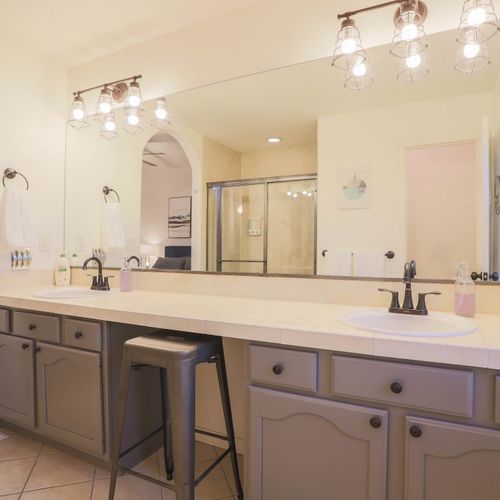 Master bathroom with dual sinks, walk-in shower, and an expansive vanity.