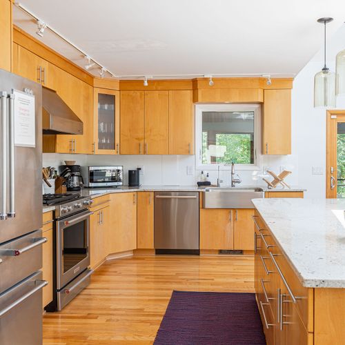 A spacious kitchen with stainless steel appliances awaits your culinary creativity.