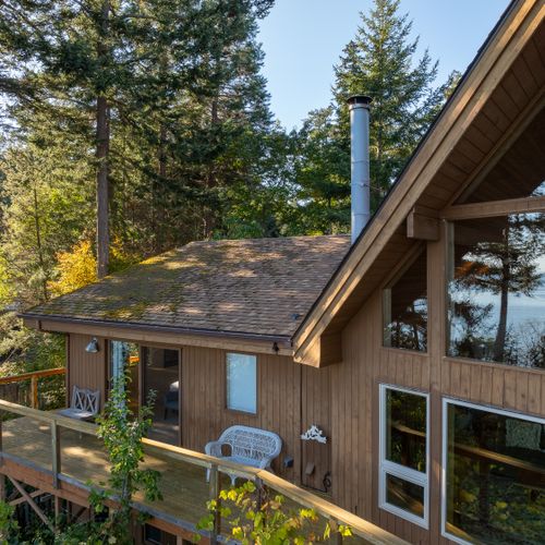 The main bedroom balcony is protected by trees with dappled sunlight streaming in.