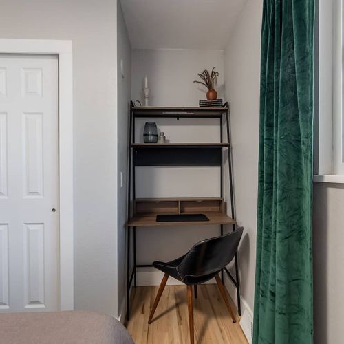- stay productive with a dedicated desk and comfy chair nestled into a quiet corner
- natural light from the window makes this a perfect spot for work or journaling
- shelves with charming decor and essentials keep your workspace organized and inspir