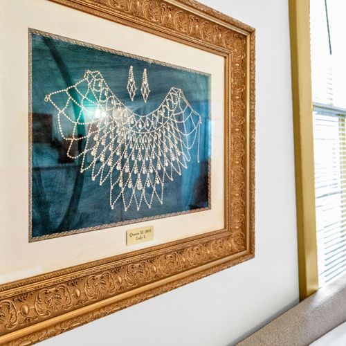 Gold-framed coastal artwork that brings local character to the walls.