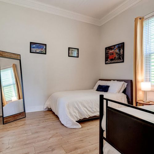 Second bedroom w/ two twin beds, a full, & a full-body mirror — room to spread out.