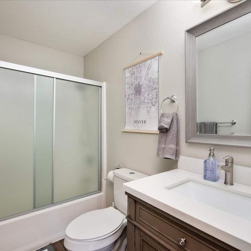 You’ll find two clean and fully stocked bathrooms in this home with two shower/tub combos. They feature bright lighting, large mirrors, hotel grade towels, and all the bathroom essentials, like shampoo, conditioner, and body wash that your group may