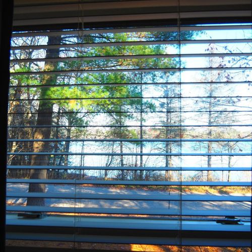 Bedroom #1 (main floor):  features a queen-size bed, dresser, nightstand, mirror, closet, ceiling fan, and a very nice lake view!