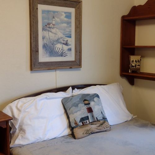 Bedroom #1:  features a full-size bed, nightstand, lamp, dresser. And closet.