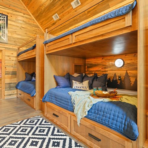 A magical room where everyone gets their own cozy corner under the glow of soft moonlit scenes.