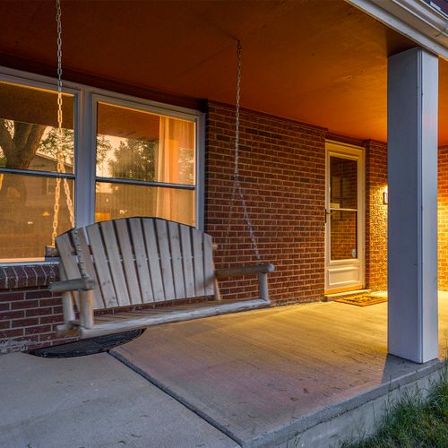 At night, the porch swing becomes a cozy haven, gently swaying under the stars, perfect for romantic conversations or simply unwinding after a long day.